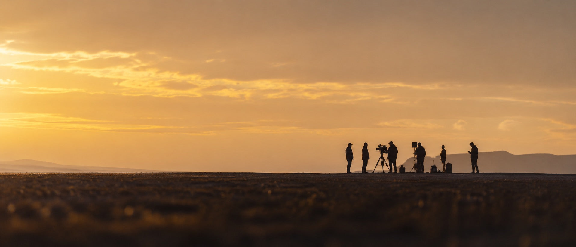 Film crew working at sunset